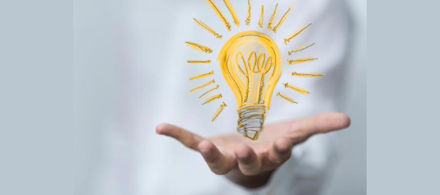 Open palm of a hand holding an illustration of a lightbulb