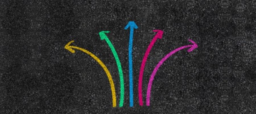 multiple colourful arrows on a road pointing in different directions